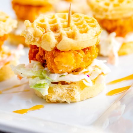 Chicken and Waffle Sliders with coleslaw and syrup.
