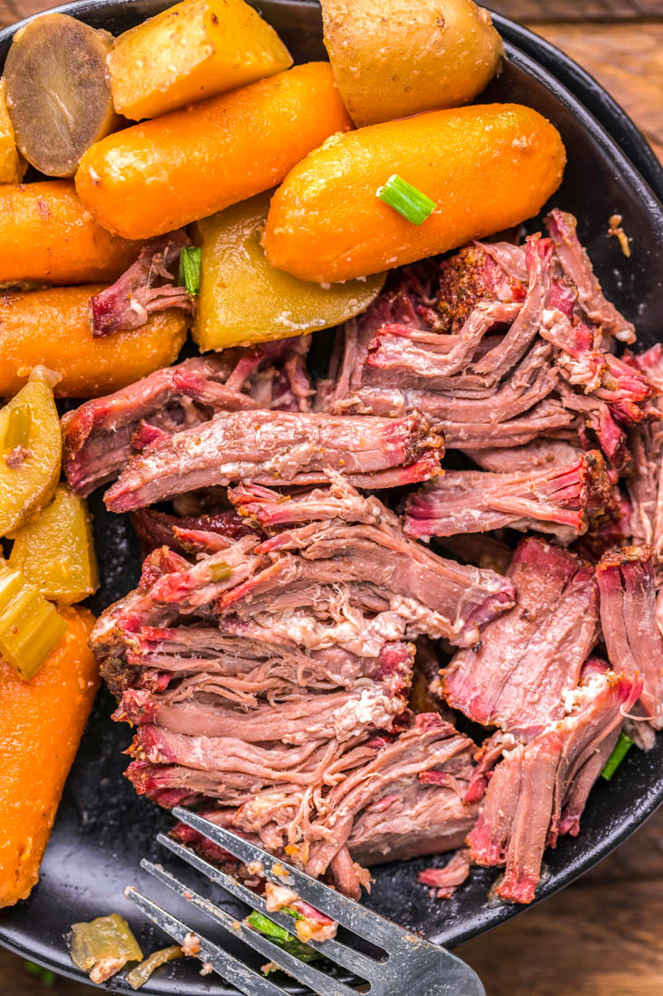 A close up picture of the finished shredded pot roast meat that was cooked in a smoker.