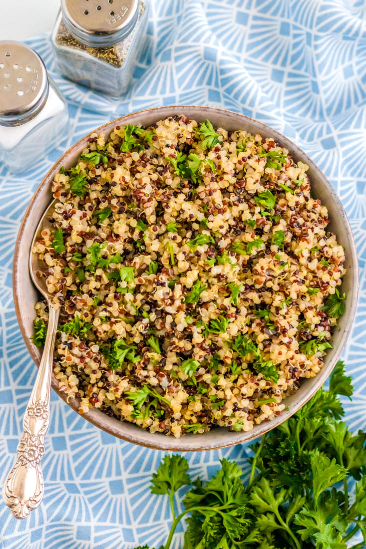 An overhead picture of the finished Quinoa in a serving bowl with a spoon.