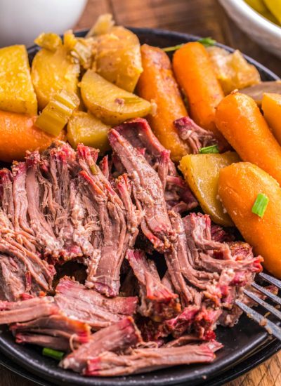 The finished Smoked Pot Roast on a black plate.