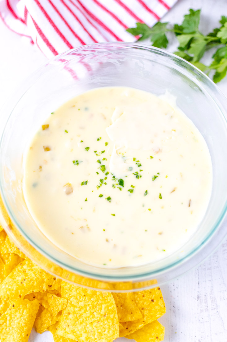 An overhead picture of the finished Velveeta Queso Dip Recipe in a clear glass bowl.