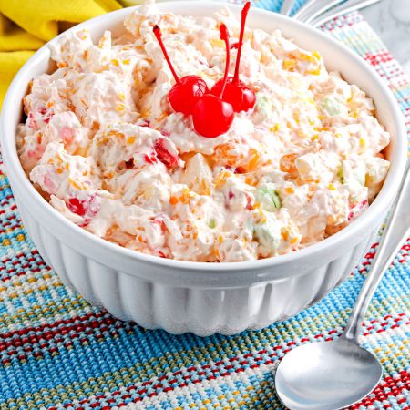 The finished Ambrosia Fruit Salad in a white serving bowl.