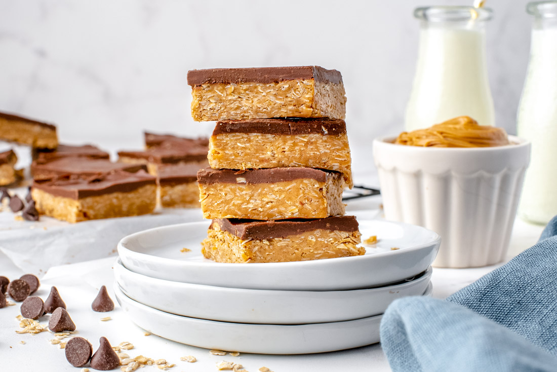 The finished peanut butter bars on a white plate.