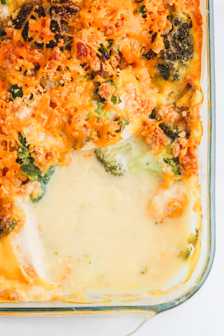 An overhead picture of the finished Cracker Barrel Broccoli Cheddar Chicken Casserole with some of it take out so you can see what it looks like on the inside.