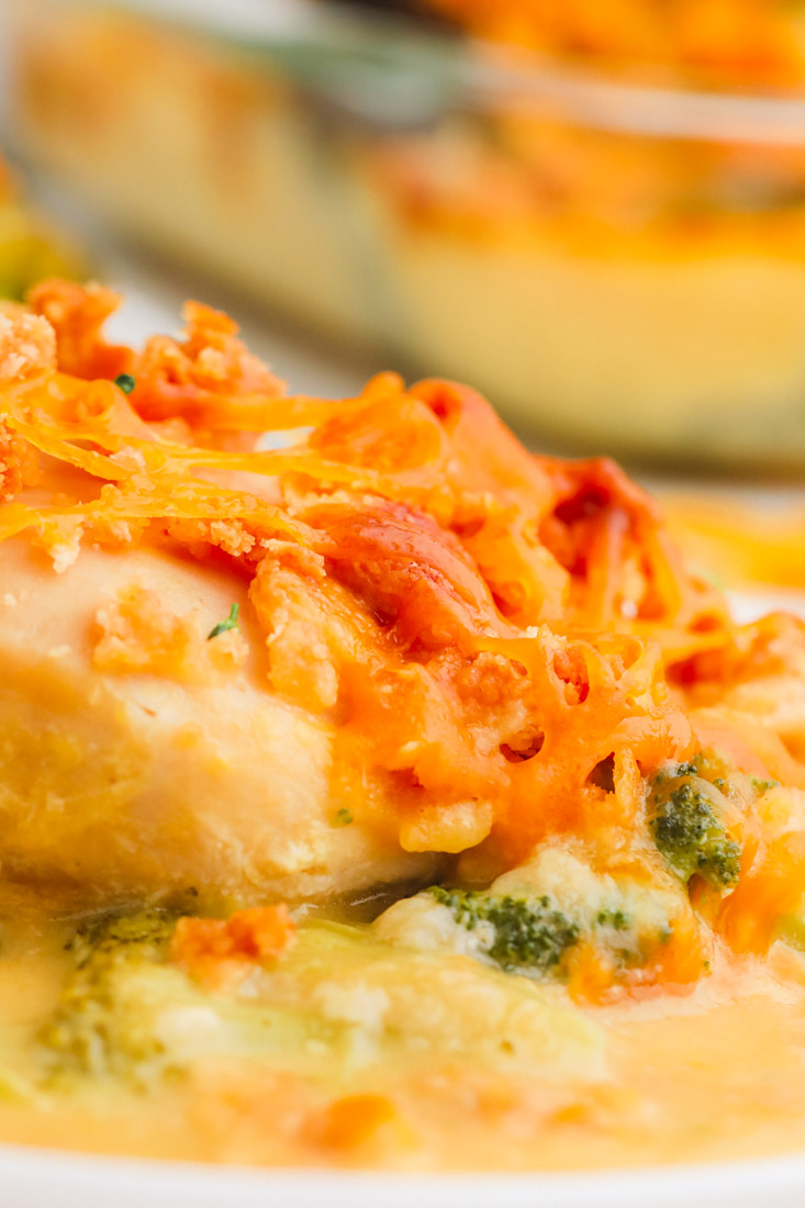 A close up picture of the finished Cracker Barrel Broccoli Cheddar Chicken on a white plate.