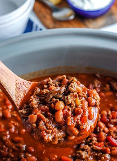 A ladle picking up some of the crockpot chili.