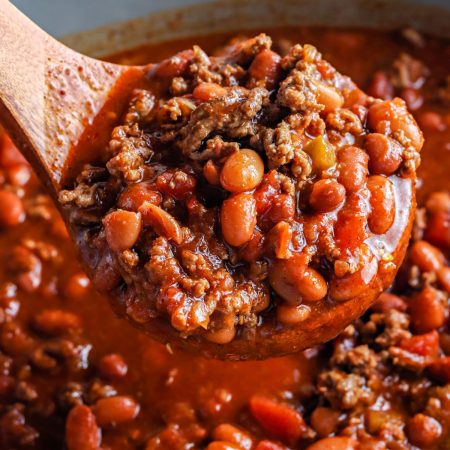 A close up of the finished crockpot chili in a soup ladle.