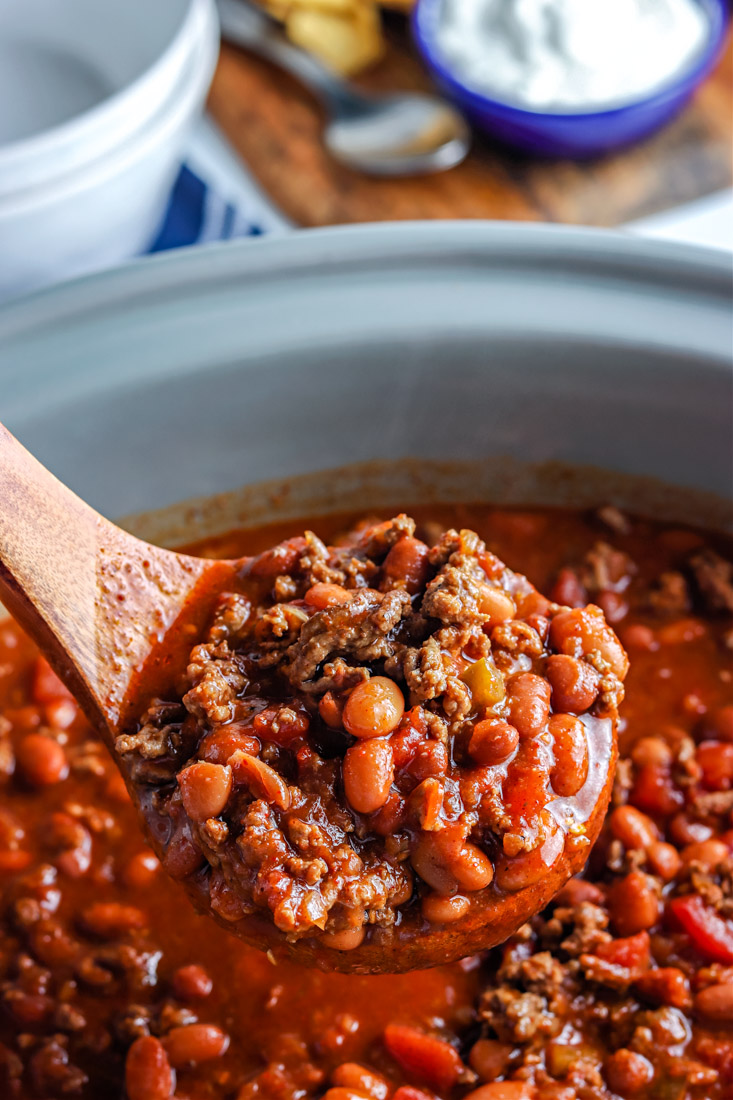 A ladle picking up some of the crockpot chili.