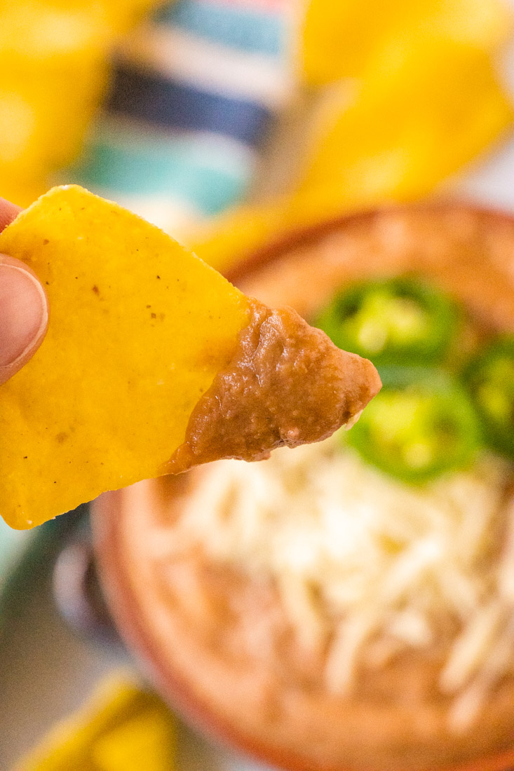 A tortilla chip dipped into canned refried beans made better.
