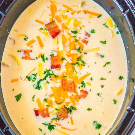 A overhead picture of the finished Slow Cooker Creamy Tortellini Soup in the crockpot.