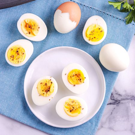An overhead picture of the finished hard boiled eggs peeled and cut in half.