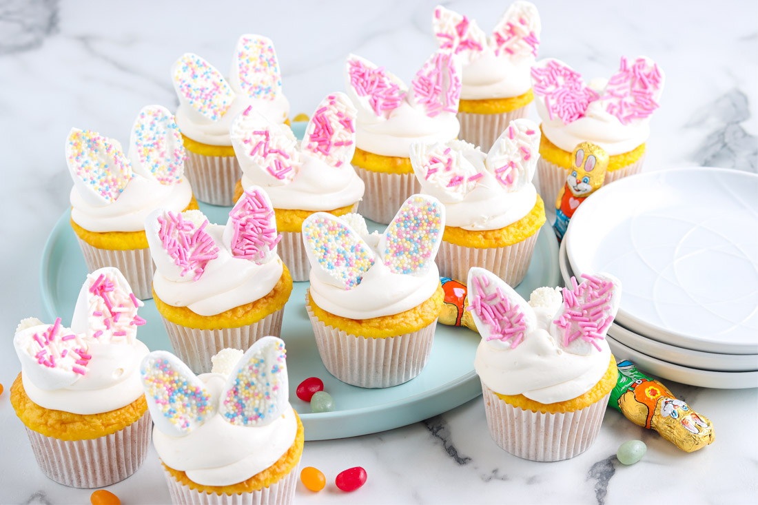The finished Bunny Cupcakes recipe on a blue platter.