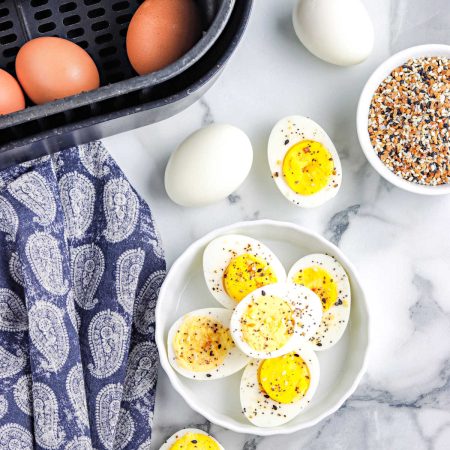 The finished hard boiled eggs cooked in an air fryer cut in half.