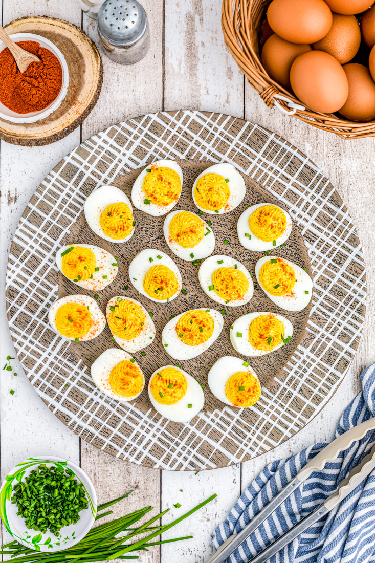An overhead picture of the finished Horseradish Deviled Eggs on a wooden platter. 