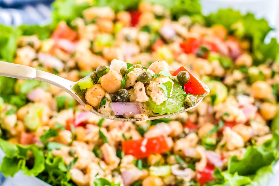 A close up picture of the finished Healthy Tuna Salad Without Mayo being listed up with a spoon.