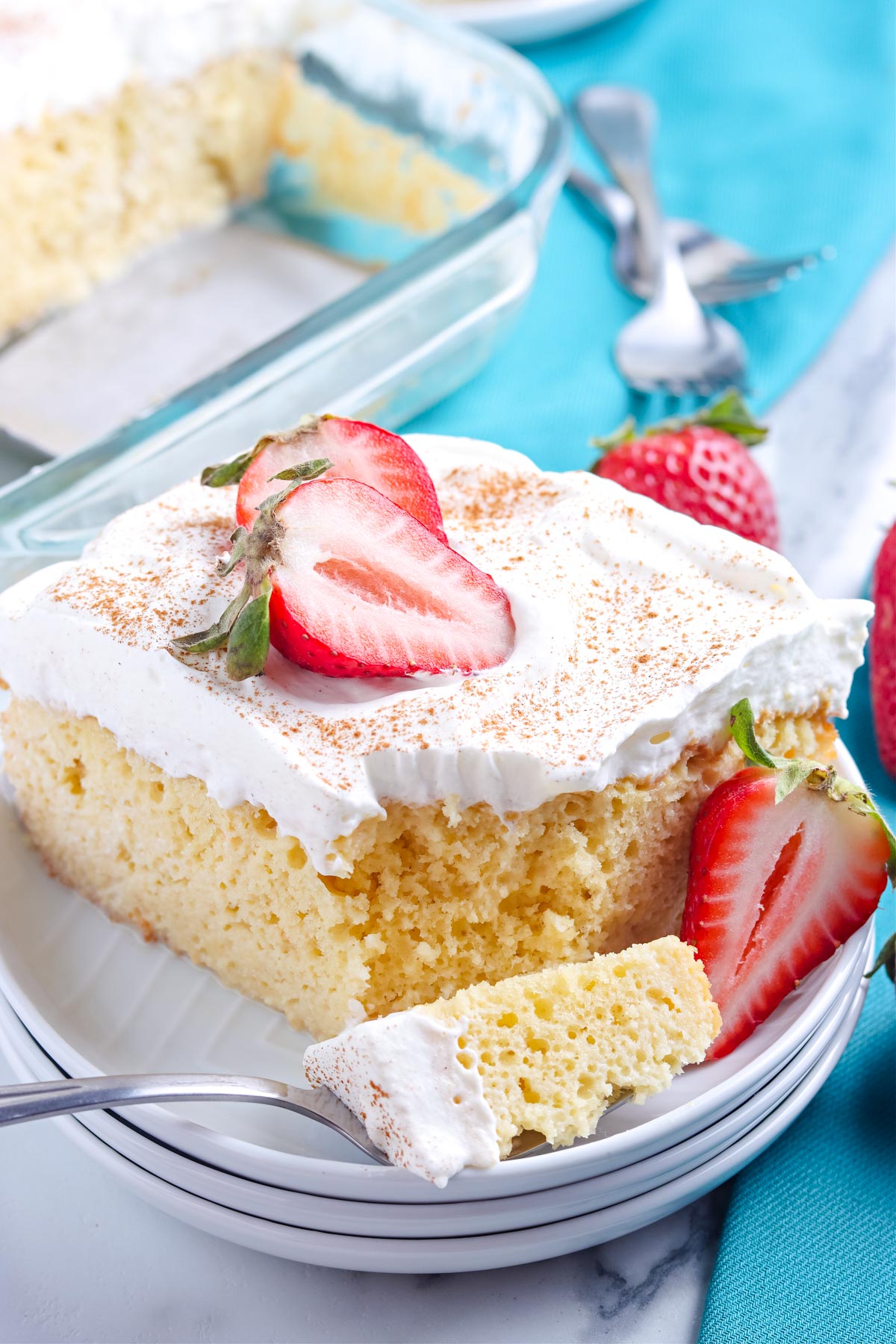 A close up picture of this easy Tres Leches Cake with a forkful taken out of it.