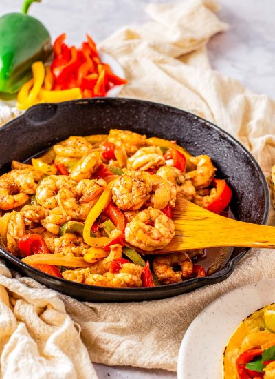 Th finished Shrimp Fajitas in a cast iron skillet ready to be served over tortillas.