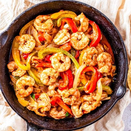 An overhead picture of the finished Shrimp Fajitas recipe in a cast iron skillet.