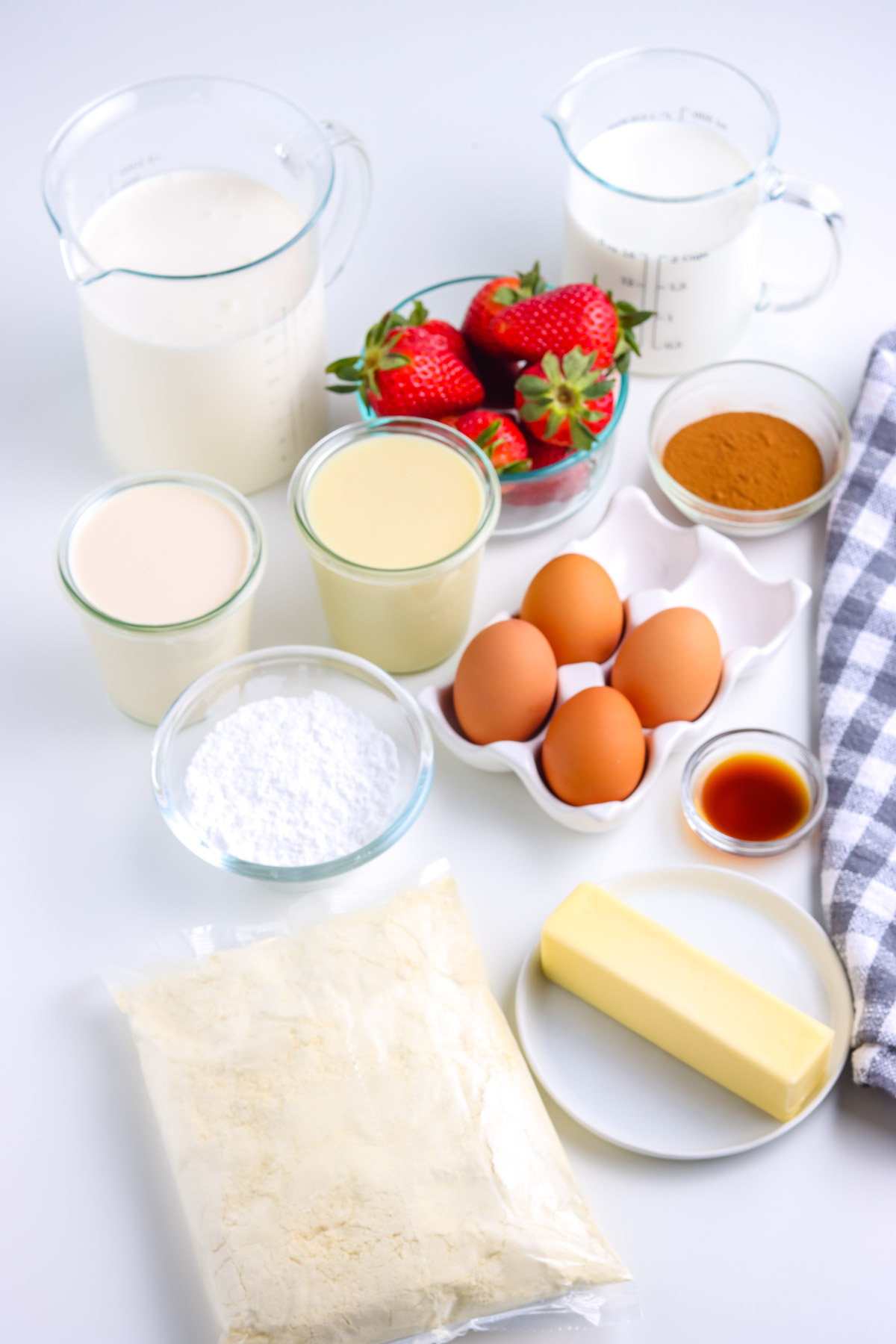 All of the ingredients needed to make this Tres Leches Cake recipe.