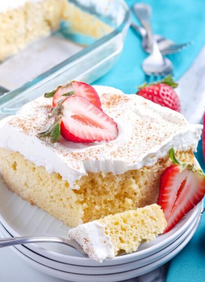 A close up picture of this easy Tres Leches Cake with a forkful taken out of it.