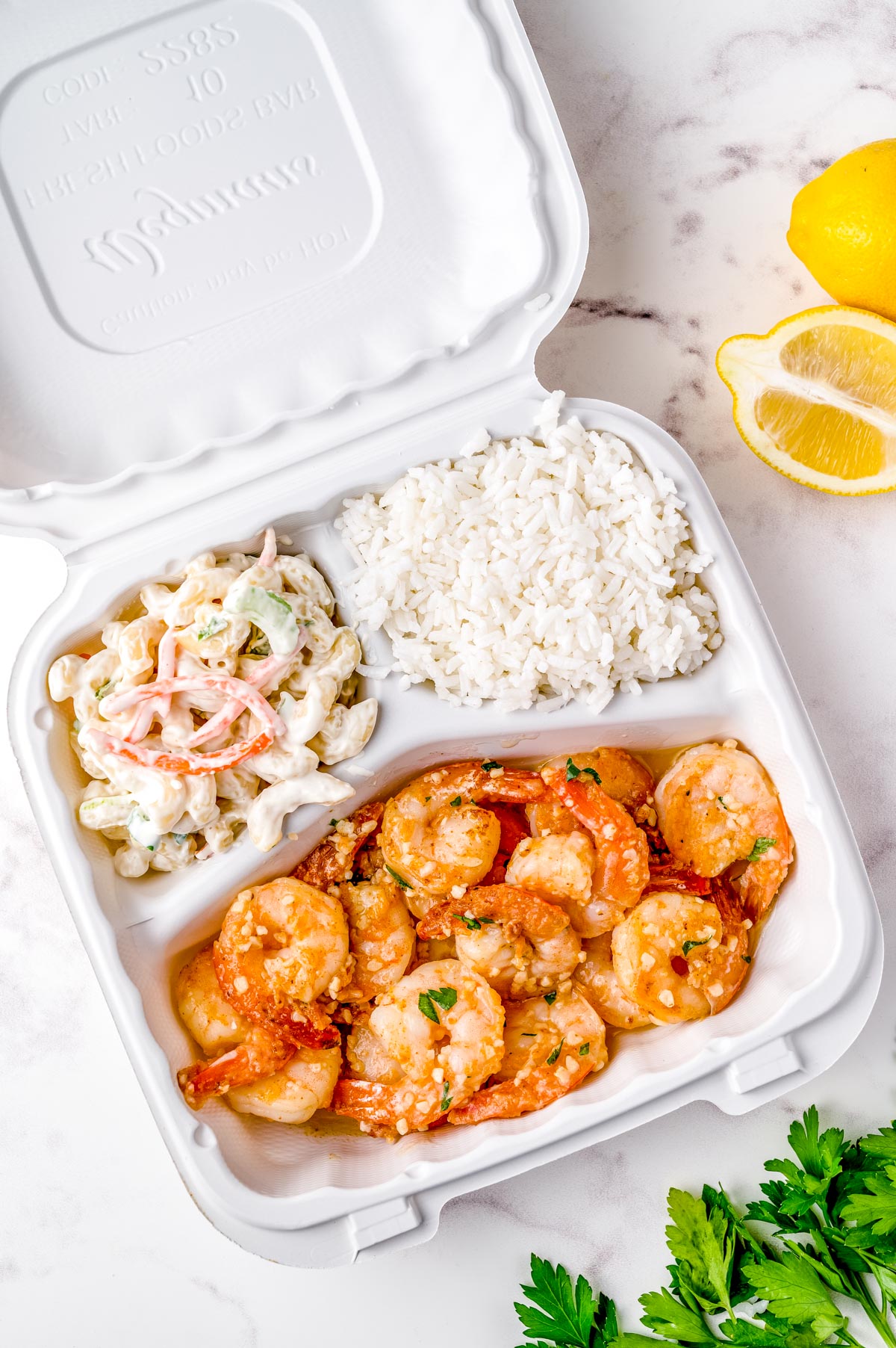 An overhead picture of this Hawaiian Style Macaroni Salad in a plate lunch with homemade garlic shrimp and white rice.