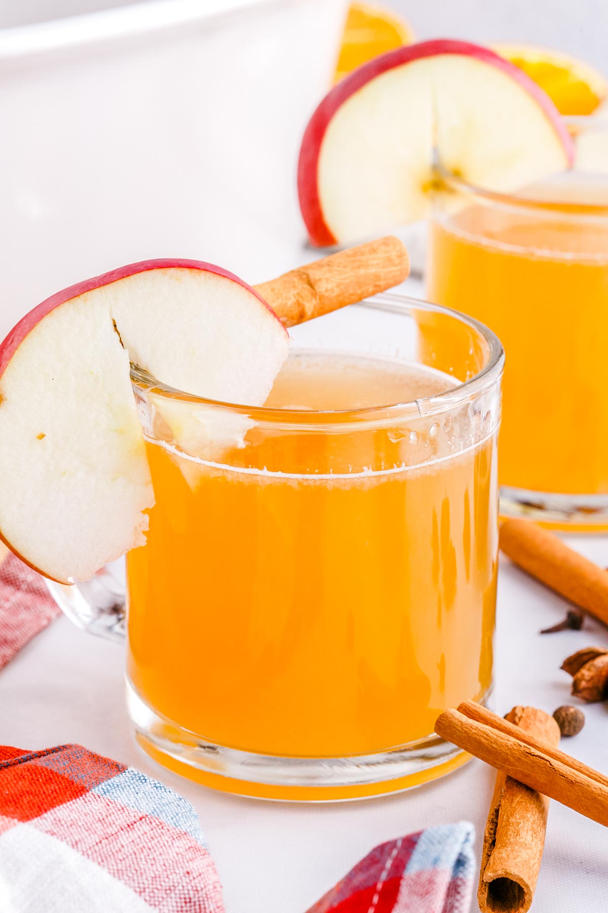 The finished Homemade Apple Cider in a clear glass mug garnished with an apple slice.