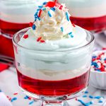 A close up picture of the Jello Parfaits recipe on a clear glass trifle dish.