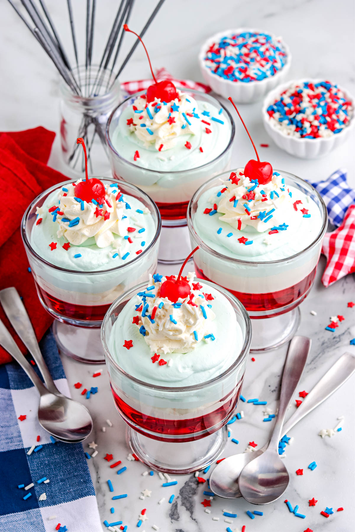 Four of the finished Jello Parfaits decorated with sprinkles.