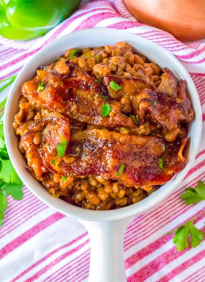 An overhead picture of the finished Loaded Baked Beans in a white serving bowl.