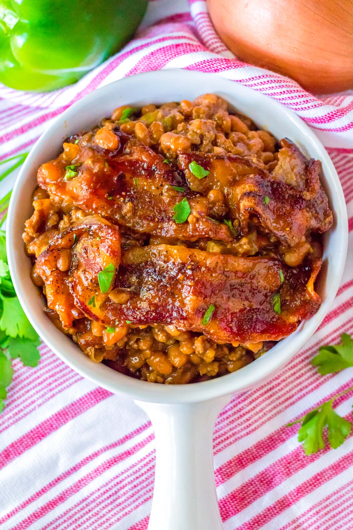 An overhead picture of the finished Loaded Baked Beans in a white serving bowl. 