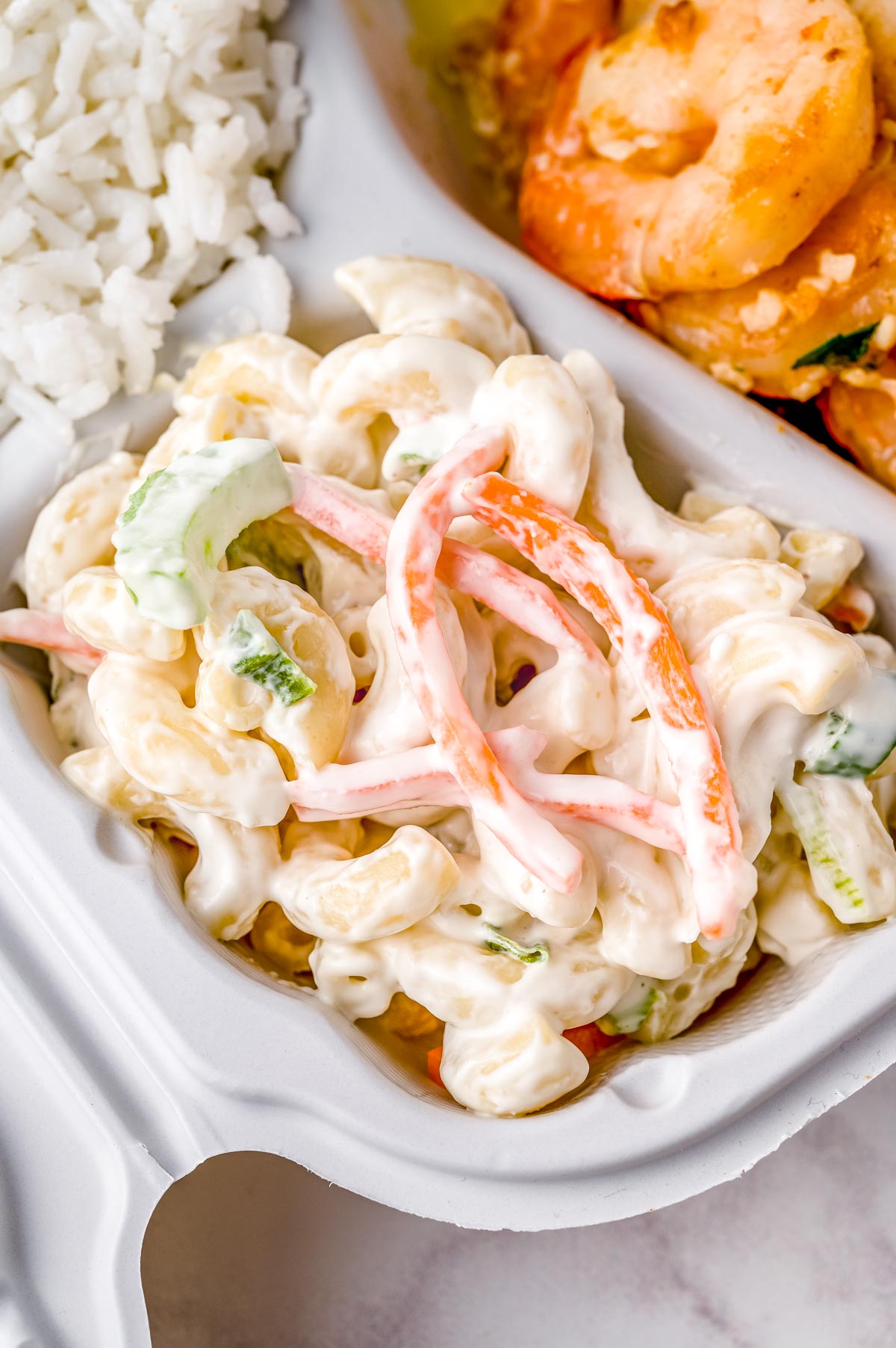 A close up picture of the finished Macaroni Salad Hawaiian Recipe in a plate lunch with garlic shrimp.
