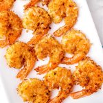 A close up picture of the finished Coconut Shrimp on a white serving platter.