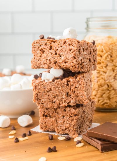 Three Chocolate Rice Krispie Treats stacked on top of each other.