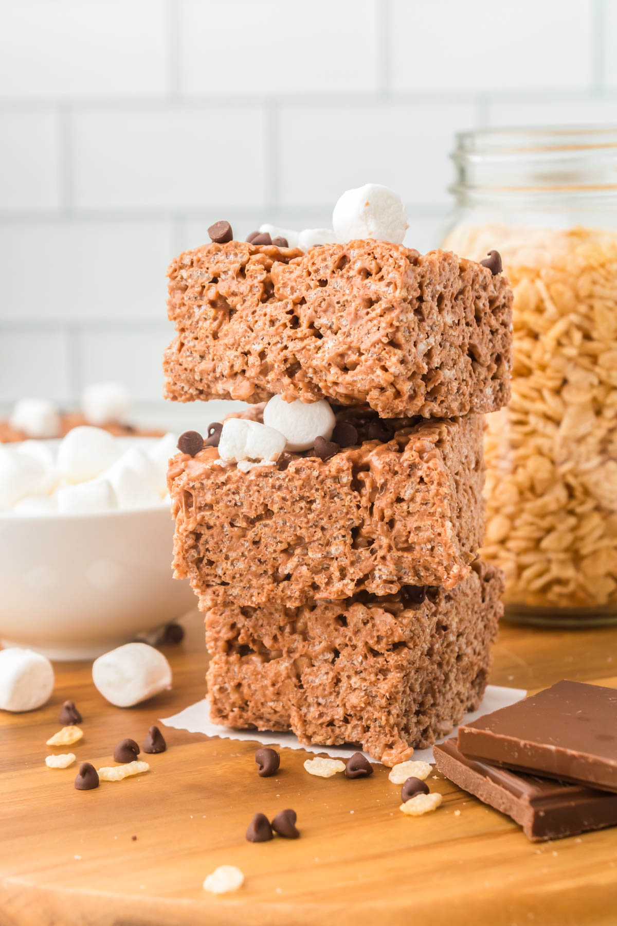 Three Chocolate Rice Krispie Treats stacked on top of each other. 