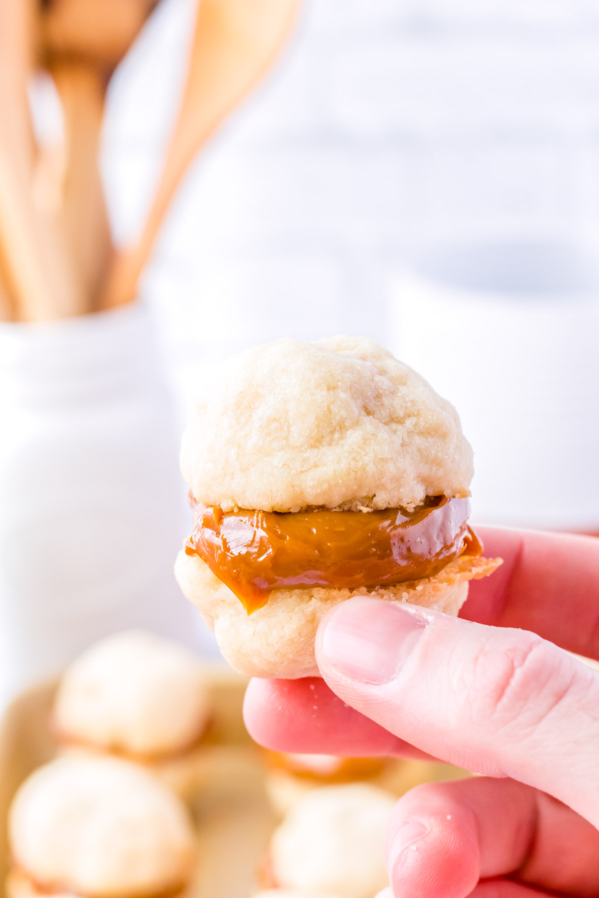 A hand picking up a finished cookie.