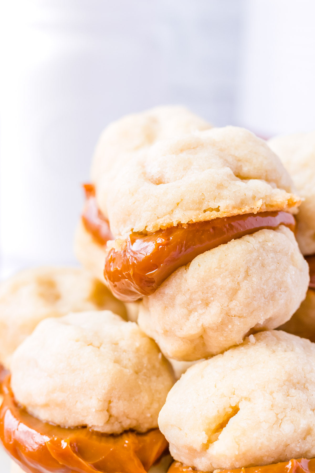 A close up picture of the finished Dulce De Leche Sandwiched Cookies piled on top of each other.