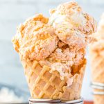 A close up picture of scoops of Butterscotch Ice Cream in a waffle cone.