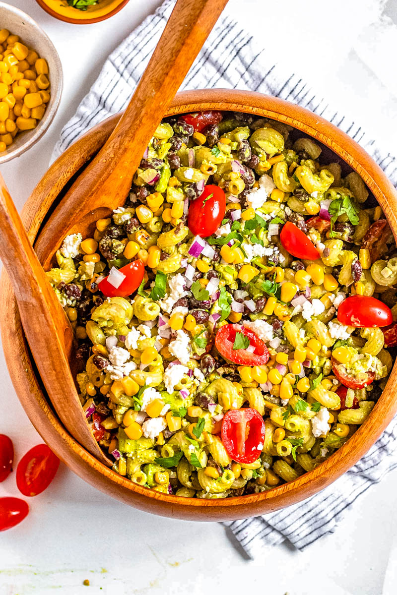 An overhead picture of the finished Mexican Corn Pasta Salad in a wooden serving bowl.