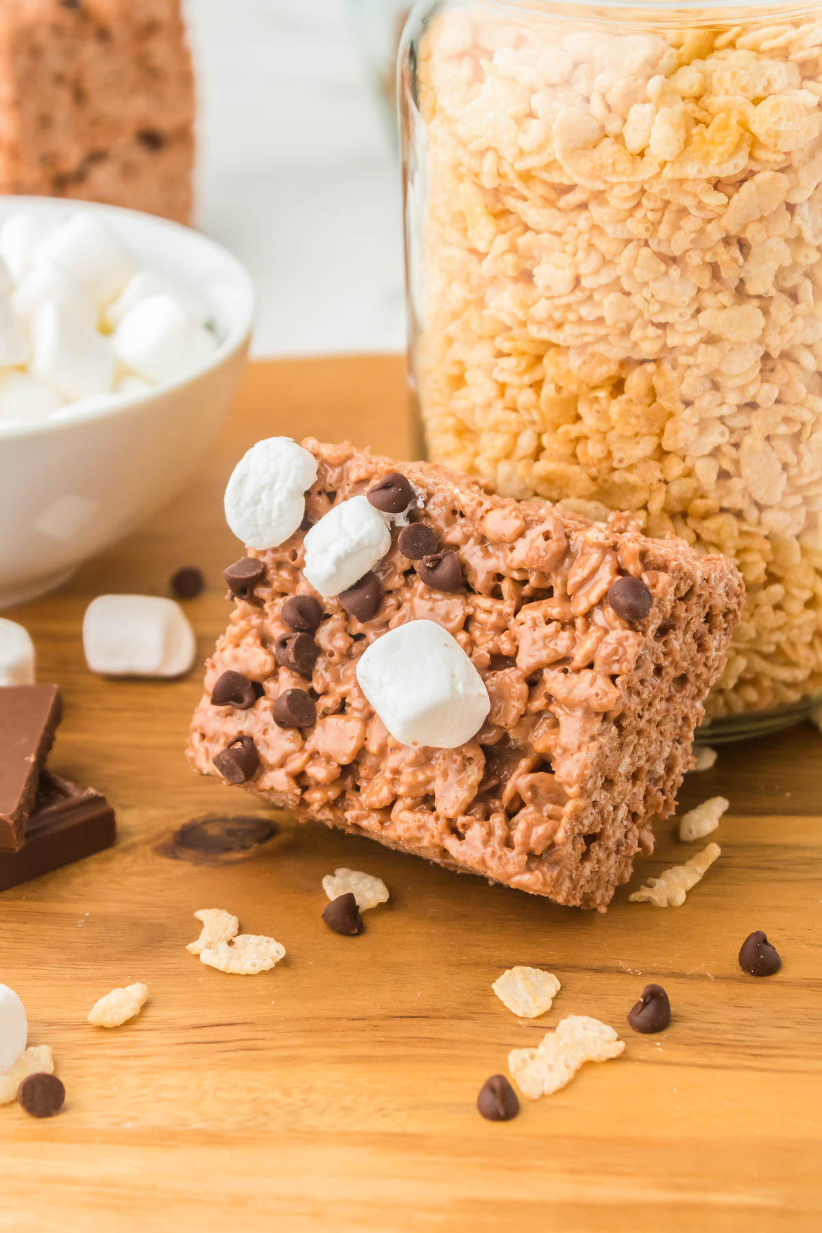 A finished Chocolate Rice Krispie Treat on a wooden cutting board.