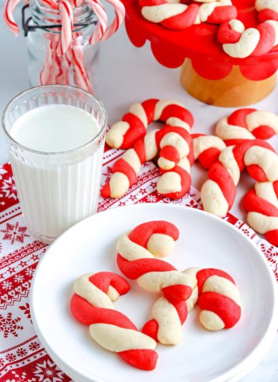 Some of the finished Candy Cane Cookies on a white plate.
