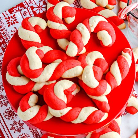 An overhead picture of the finished Candy Cane Cookies recipe on a red serving platter.