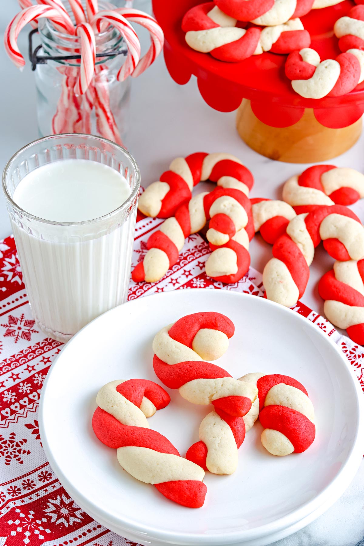 Some of the finished Candy Cane Cookies on a white plate.