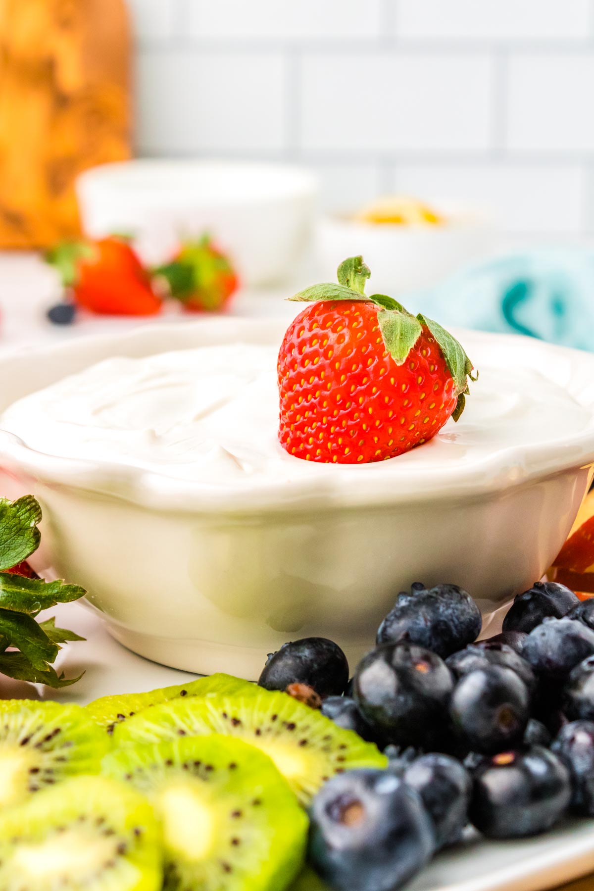 A strawberry int he Cream Cheese Fruit Dip.