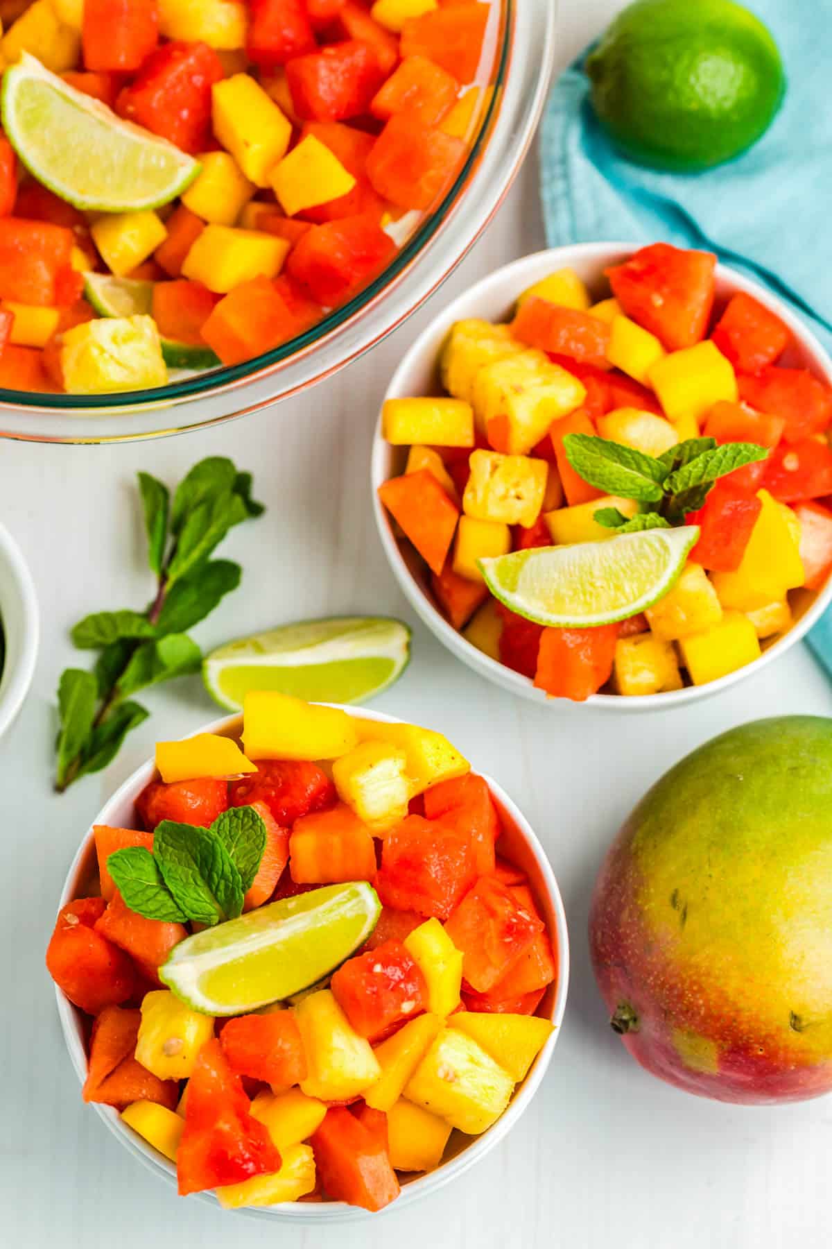 Two white bowls of fruit salad.