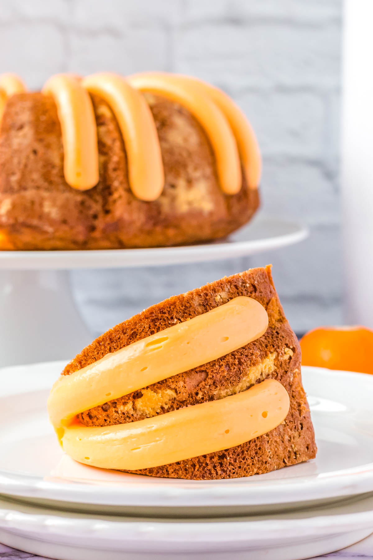 The finished Orange Bundt Cake sliced on a white plate.