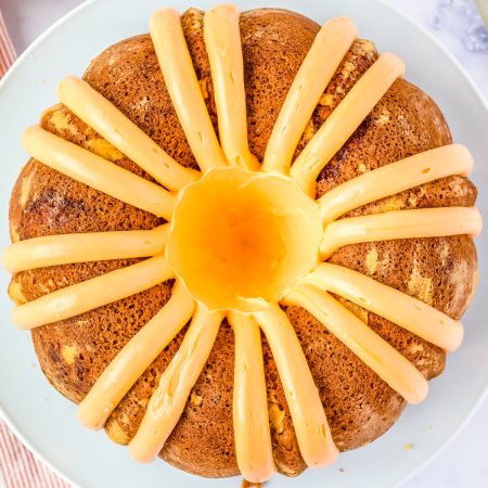 A close up picture of the finished orange cake on a white platter.