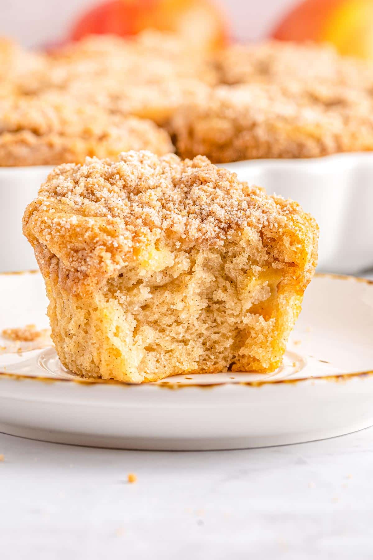 A bite taken out of an Cinnamon Apple Muffin.