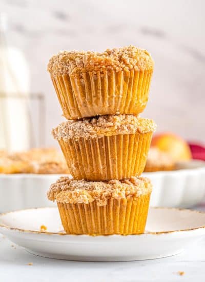 Three Cinnamon Apple Muffins stacked on top of each other.