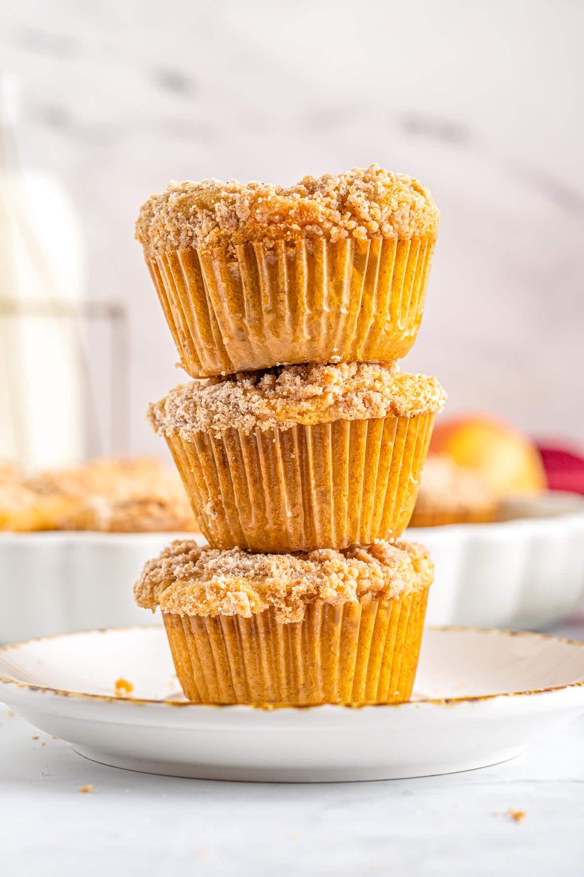 Three Cinnamon Apple Muffins stacked on top of each other. 