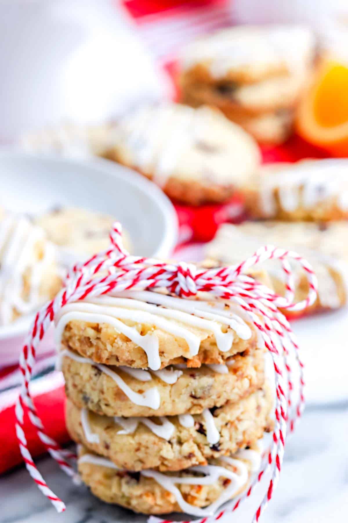 A stack of four cranberry icebox cookies stacked on top of each other.